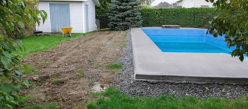 Backyard pool surround with a concrete deck and ground prepared for artificial turf beside it in the San Fernando Valley